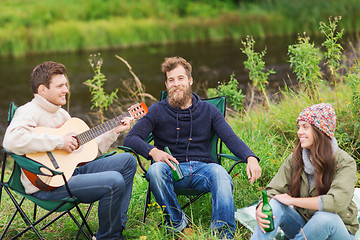 Image showing group of tourists playing guitar in camping
