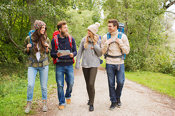 Image showing group of smiling friends with backpacks hiking