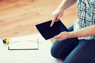 Image showing male with tablet pc, blueprint and measuring tape