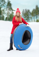 Image showing happy teenage girl or woman with snow tube