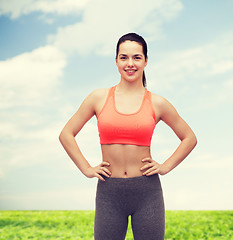 Image showing smiling teenage girl in sportswear