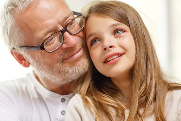 Image showing grandfather with crying granddaughter at home