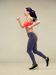 Image showing sporty woman running or jumping