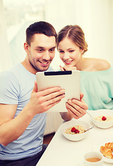 Image showing smiling couple with taking picture with tablet pc