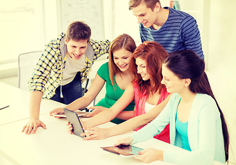 Image showing smiling students with tablet pc at school