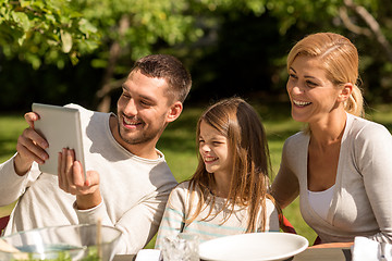 Image showing happy family with tablet pc outdoors