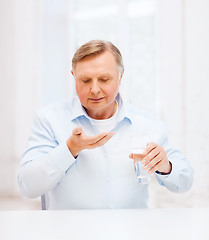 Image showing old man with pills ang glass of water