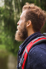 Image showing smiling man with beard and backpack hiking