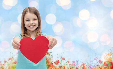 Image showing smiling girl with red heart natural background