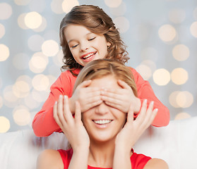 Image showing happy mother and daughter playing guess who game