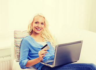 Image showing smiling woman with laptop computer and credit card