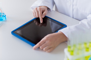 Image showing close up of scientist with tablet pc in lab