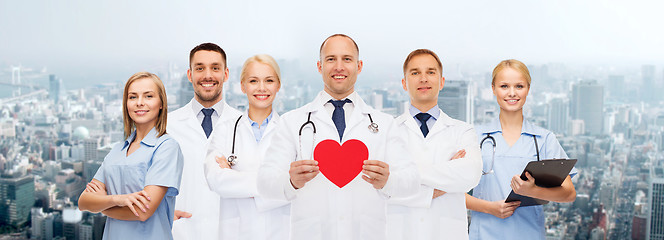 Image showing group of smiling doctors with red heart shape