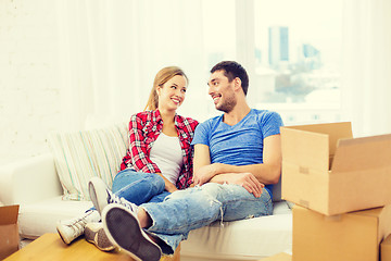 Image showing smiling couple relaxing on sofa in new home