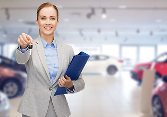 Image showing businesswoman or saleswoman giving car key