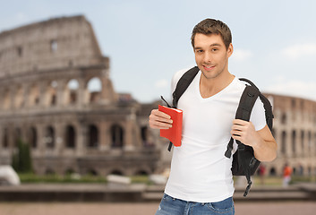 Image showing happy young man with backpack and book travelling