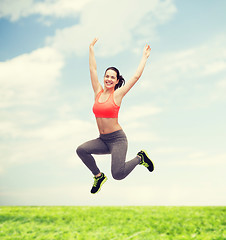 Image showing sporty teenage girl jumping in sportswear