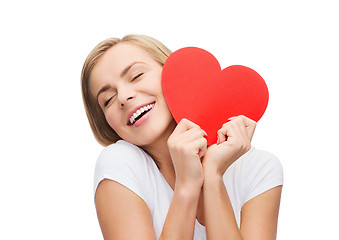 Image showing smiling woman in white t-shirt with heart