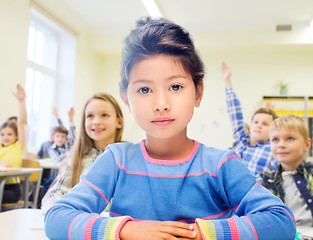 Image showing little school girl over classroom background