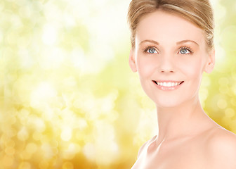 Image showing close up of smiling woman over yellow background