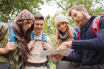 Image showing group of smiling friends with backpacks hiking