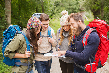 Image showing group of smiling friends with backpacks hiking