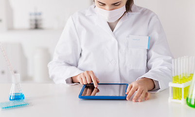 Image showing close up of scientist with tablet pc in laboratory