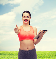 Image showing sporty woman with tablet pc computer