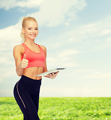 Image showing smiling sporty woman with tablet pc computer