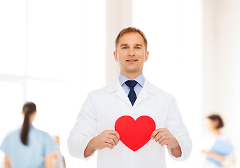 Image showing smiling male doctor with red heart