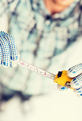 Image showing architect measuring wall with flexible ruler