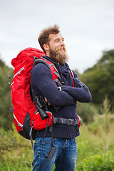 Image showing smiling man with backpack and binocular outdoors