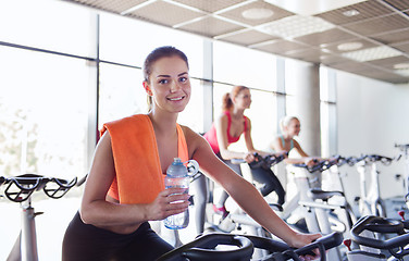 Image showing group of women riding on exercise bike in gym