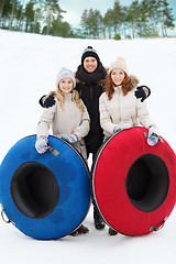 Image showing group of smiling friends with snow tubes