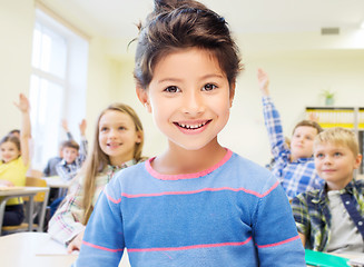 Image showing little school girl over classroom background