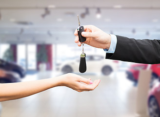 Image showing close up of customer and salesman with car key