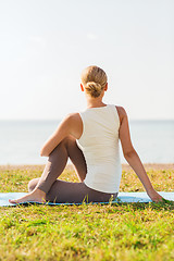 Image showing woman making yoga exercises outdoors