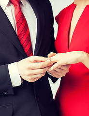 Image showing man putting  wedding ring on woman hand