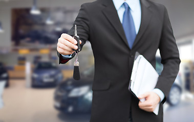 Image showing close up of businessman or salesman giving car key