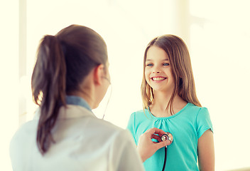 Image showing female doctor with stethoscope listening to child