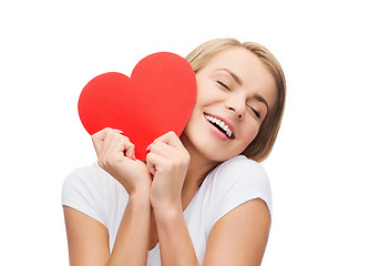 Image showing smiling woman in white t-shirt with heart