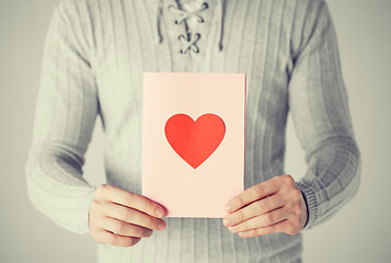 Image showing man holding postcard with heart shape