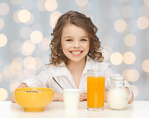 Image showing happy girl eating healthy breakfast