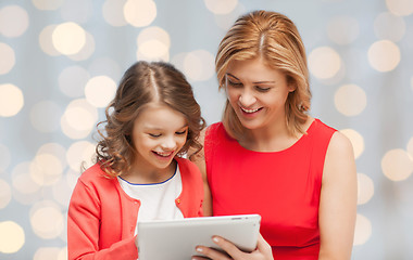 Image showing mother and daughter with tablet pc over green