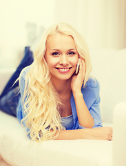 Image showing smiling woman with smartphone at home