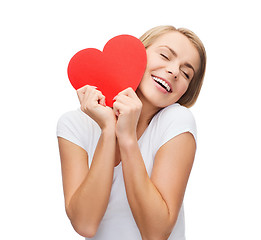 Image showing smiling woman in white t-shirt with heart