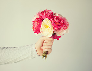 Image showing man's hand giving bouquet of flowers