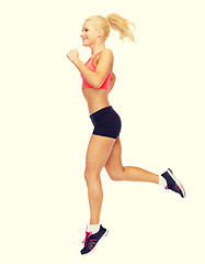 Image showing sporty woman running or jumping