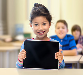 Image showing little school girl with tablet pc over classroom