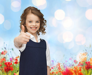 Image showing happy little school girl showing thumbs up